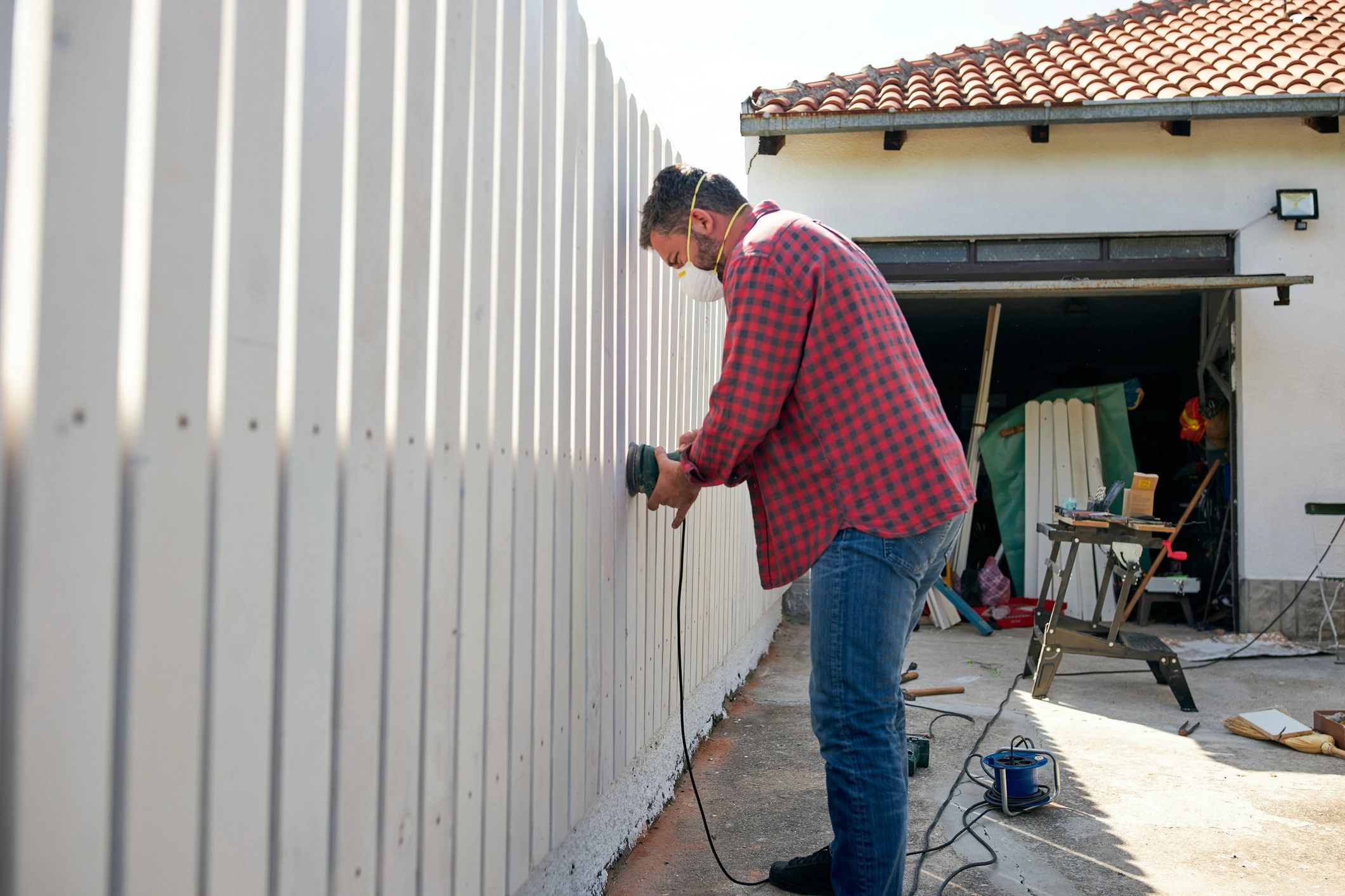 Man adding finishing touches to his fence