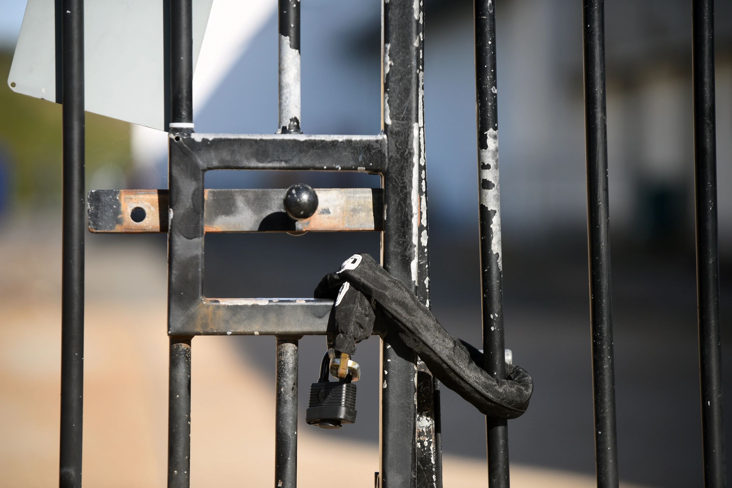 Close-up of a padlock on a gate