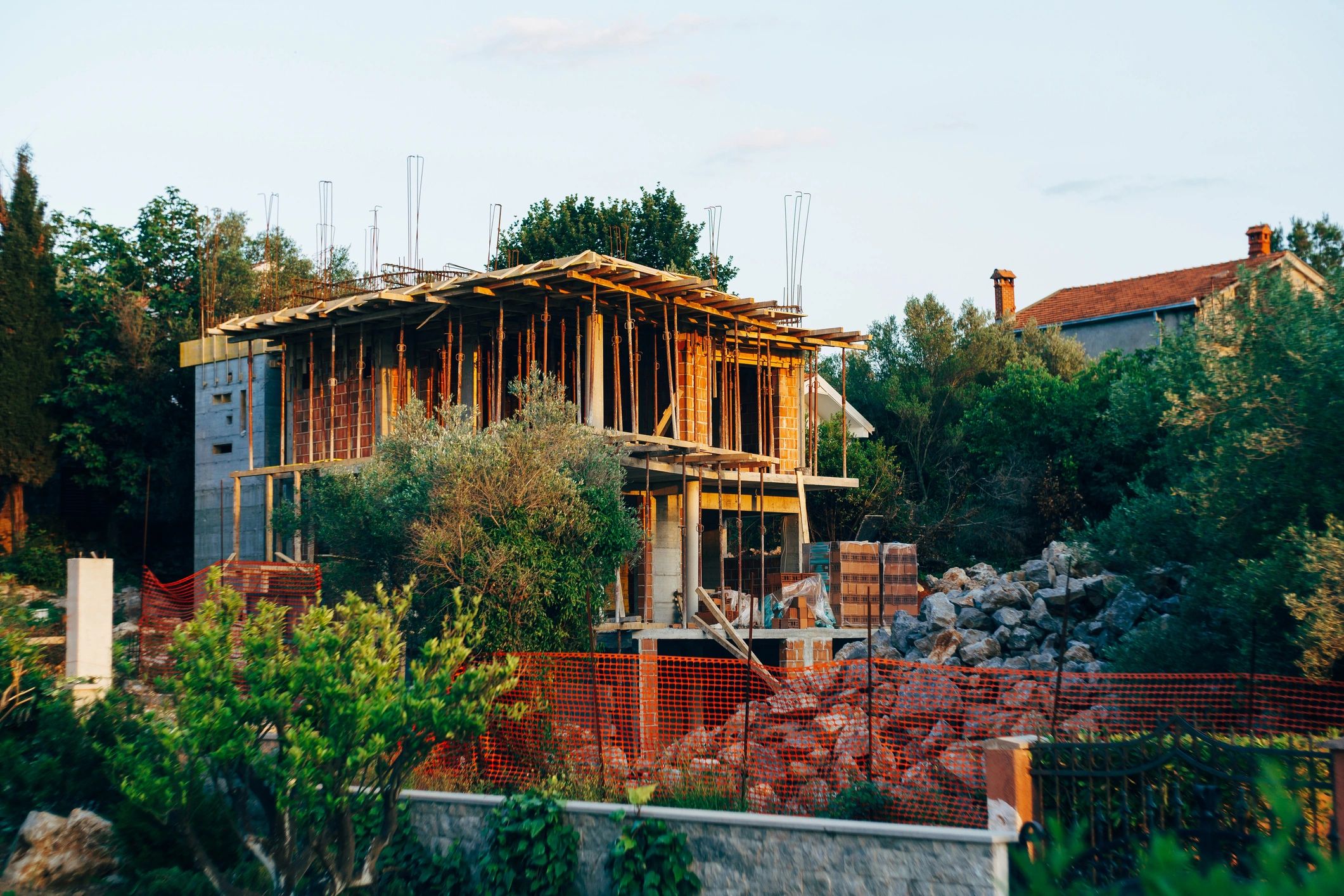 House under construction behind temporary fencing