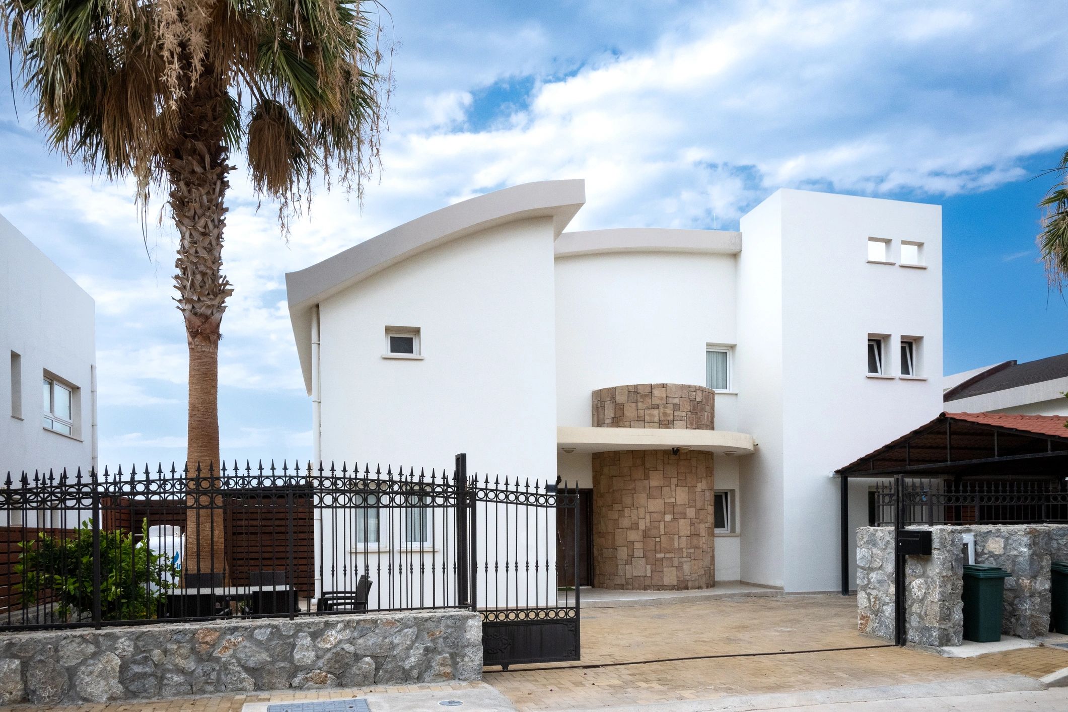 Wrought iron ornamental fence in front of a home