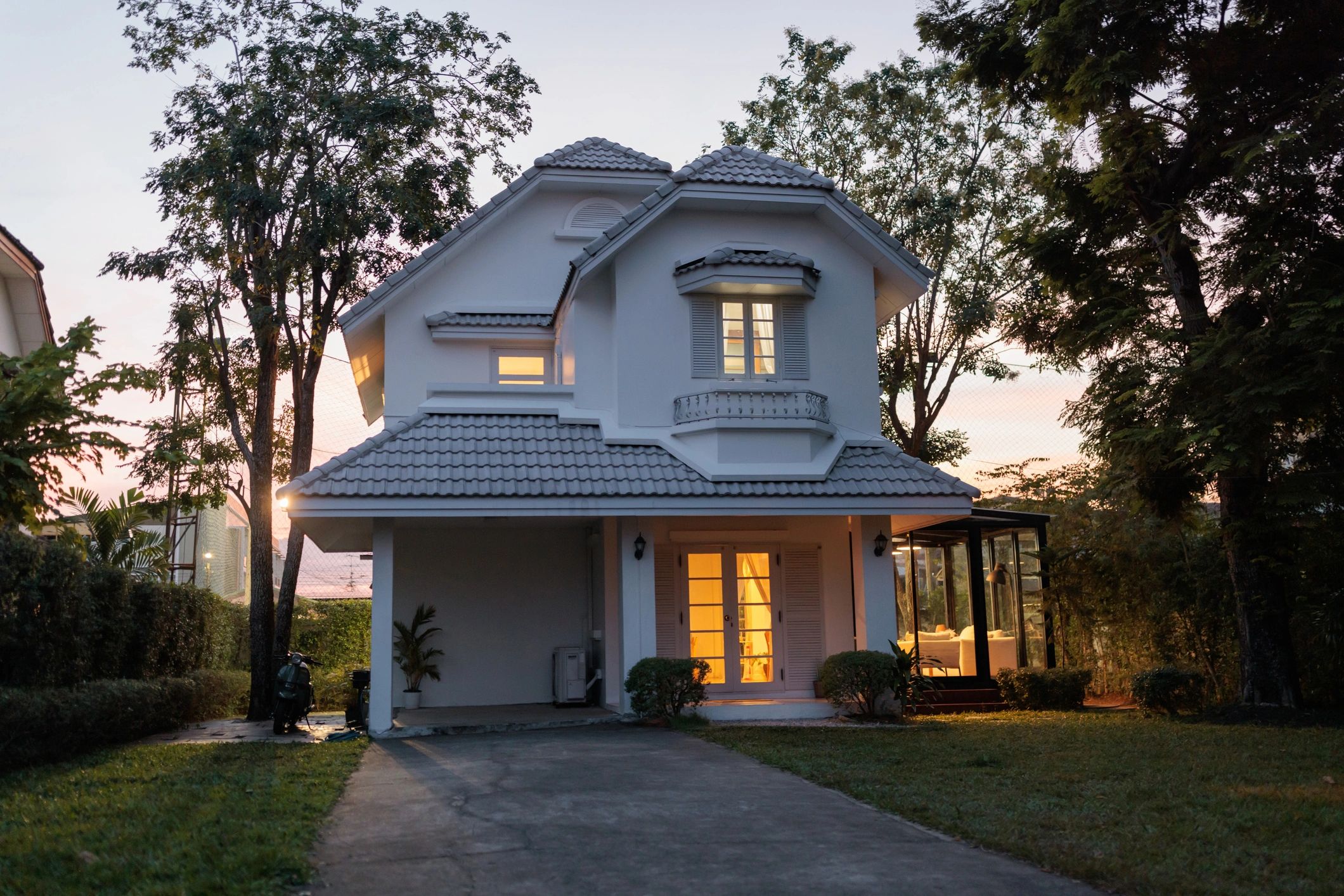 Vinyl privacy fence around a home at dusk