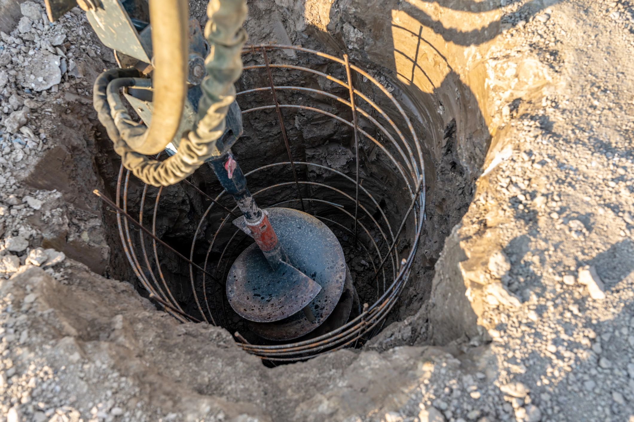 Drilling a deep hole for a reinforced concrete foundation