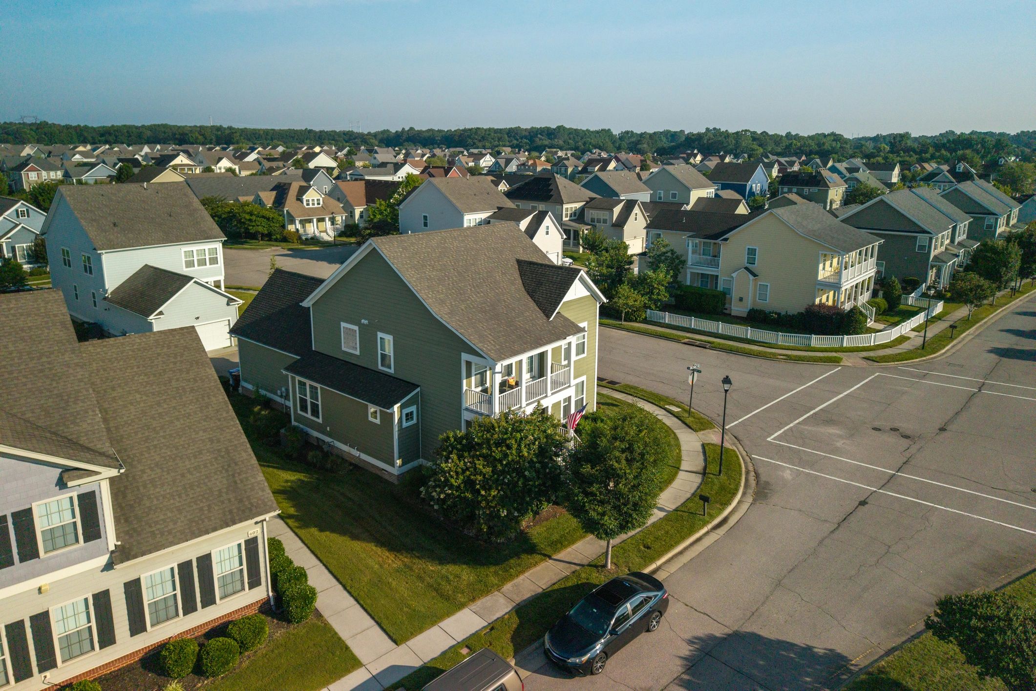 New homes with black vinyl-coated chain link fencing along the street