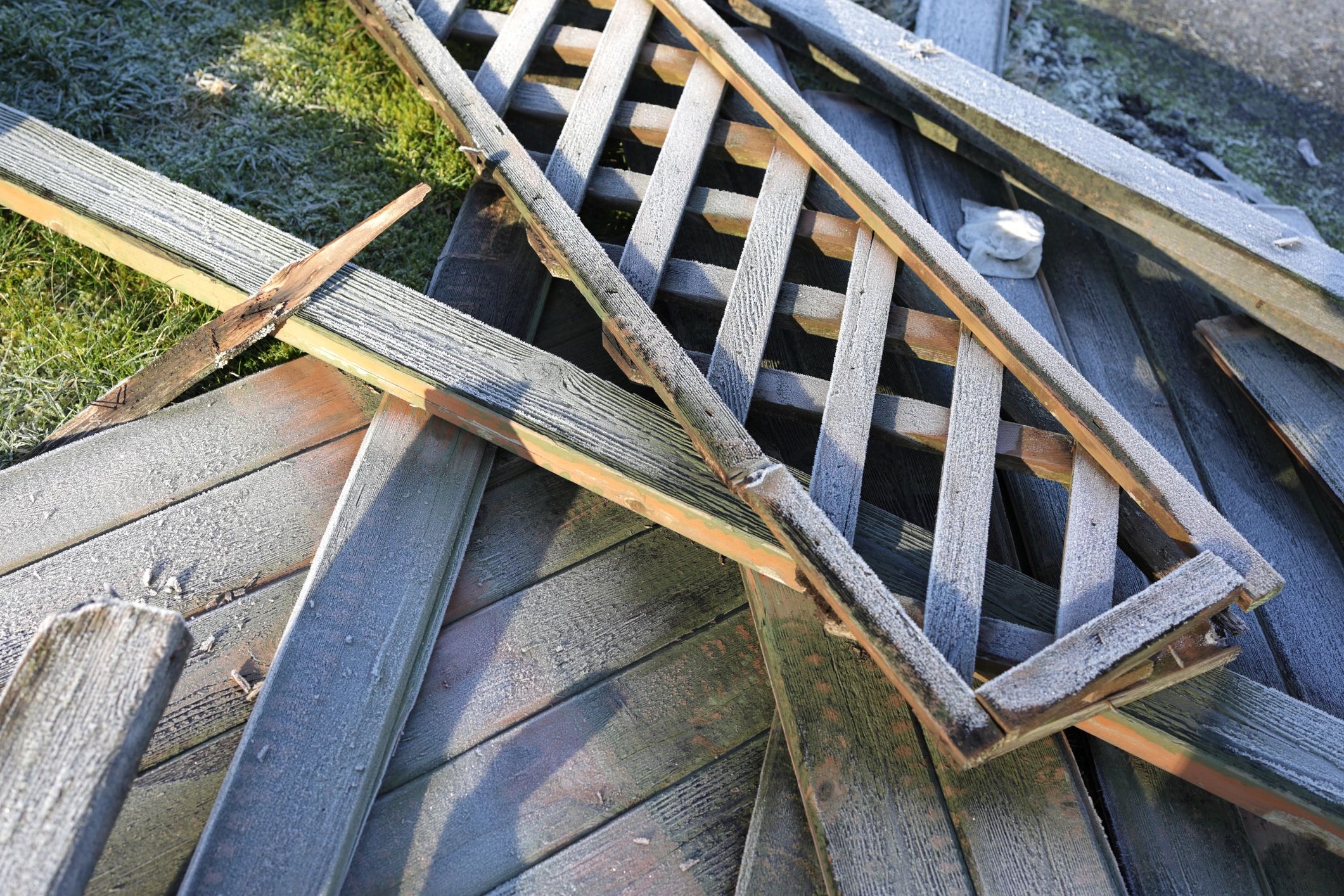 Storm-damaged fence panel before repair