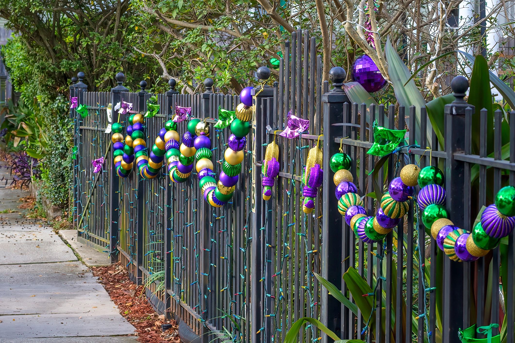 Metal fence decorated with Mardi Gras beads in New Orleans