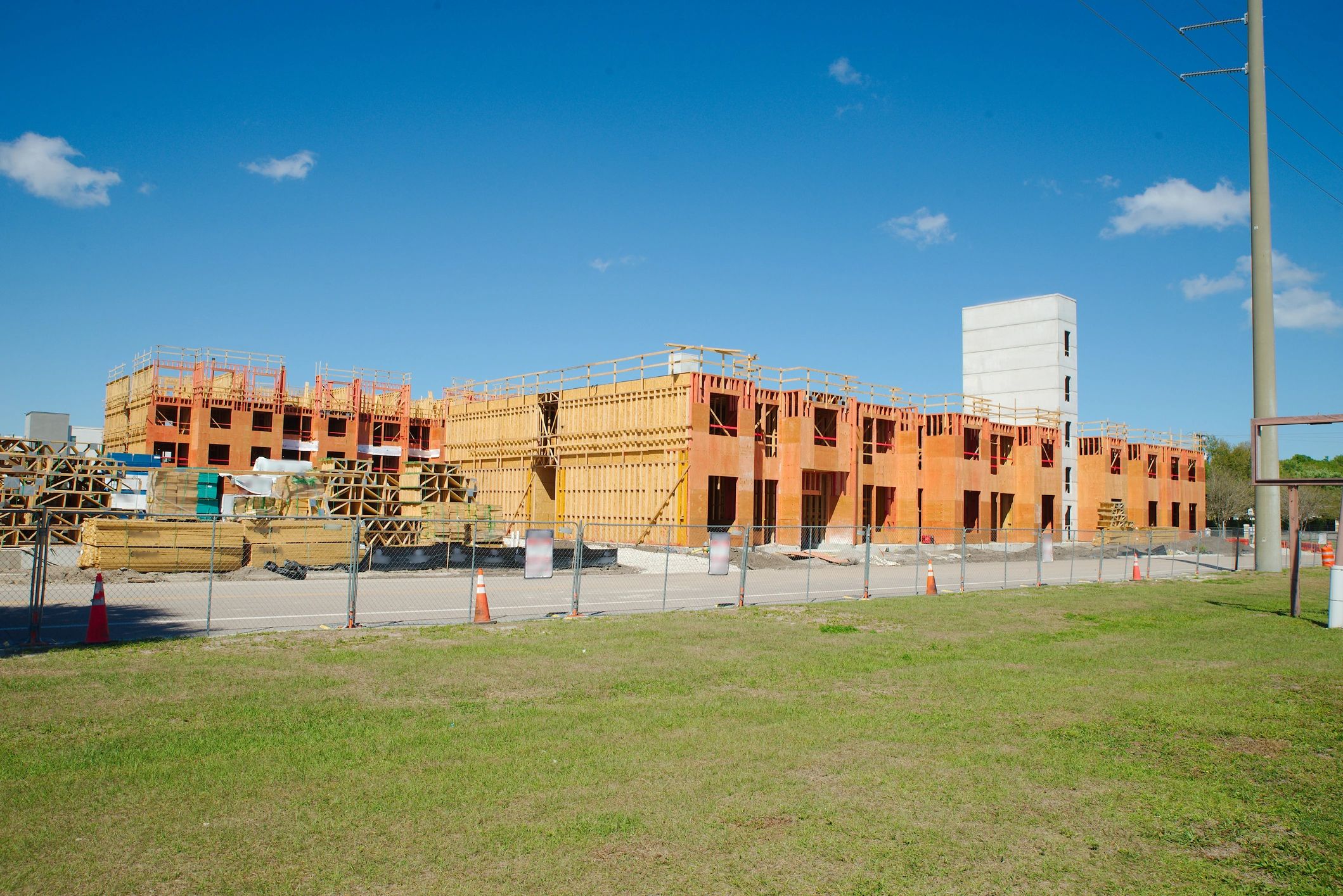 New Residential Building Construction Site With Wooden Framing and Concrete Core Under Blue Sky